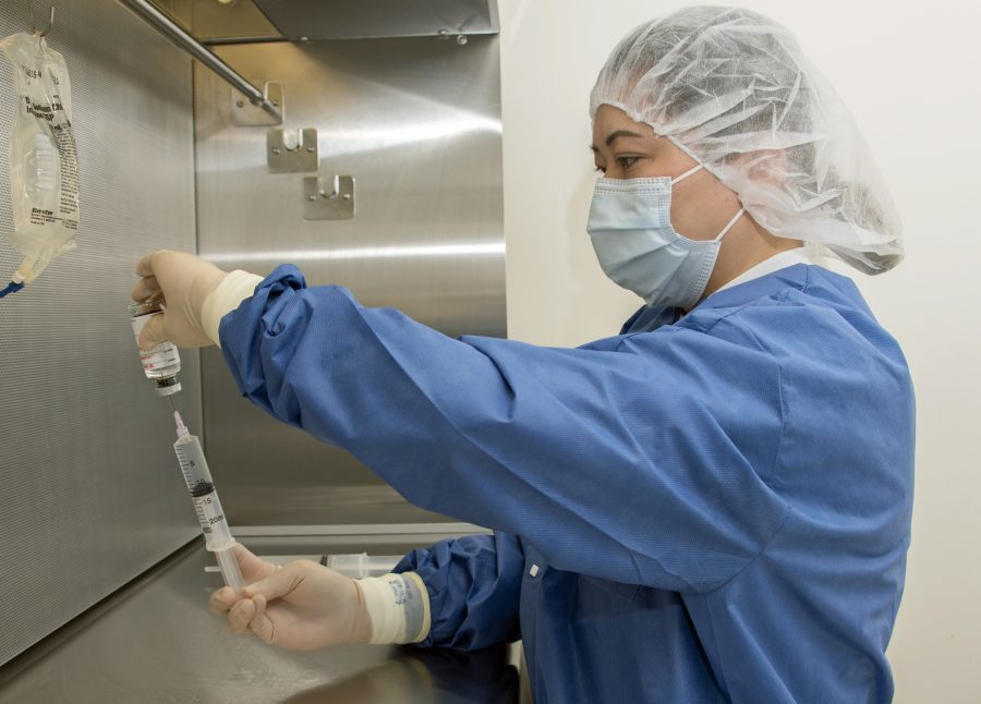 Michelle Mendoza, pharmacy technician, reconstitutes the remdesivir research drug under an intravenous hood at Brooke Army Medical Center, Fort Sam Houston, Texas, April 29, 2020. BAMC is participating in a COVID-19 treatment trial centering on the anti-viral drug, remdesivir. The National Institute of Allergy and Infectious Diseases (NIAID)-sponsored study has enrolled hundreds of people across the nation as it looks to determine if the antiviral drug is effective against COVID-19. (U.S. Army photo by Jason W. Edwards)