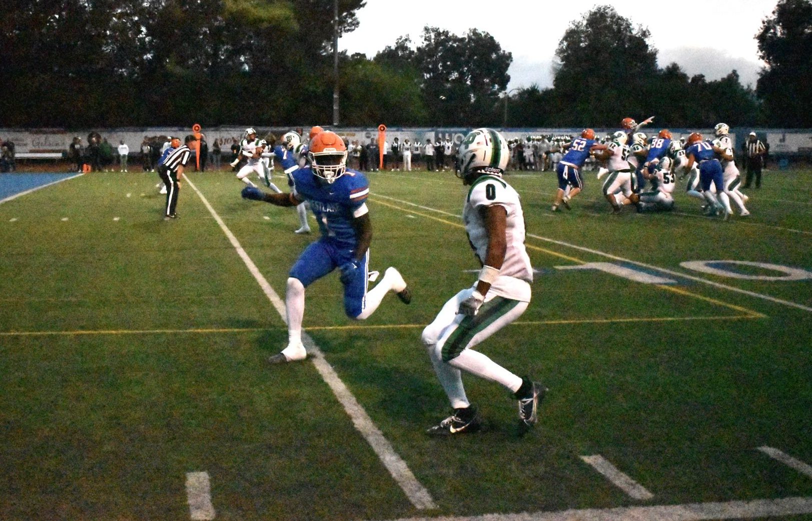 FACING OFF: WHS senior running back Ife Orekoya ‘24 battles against Thousand Oaks’ Silas Kemp  as TOHS fights their way into the endzone. The game, on Sept. 1, ended in a TOHS defeat over WHS in a 27-3 win. 